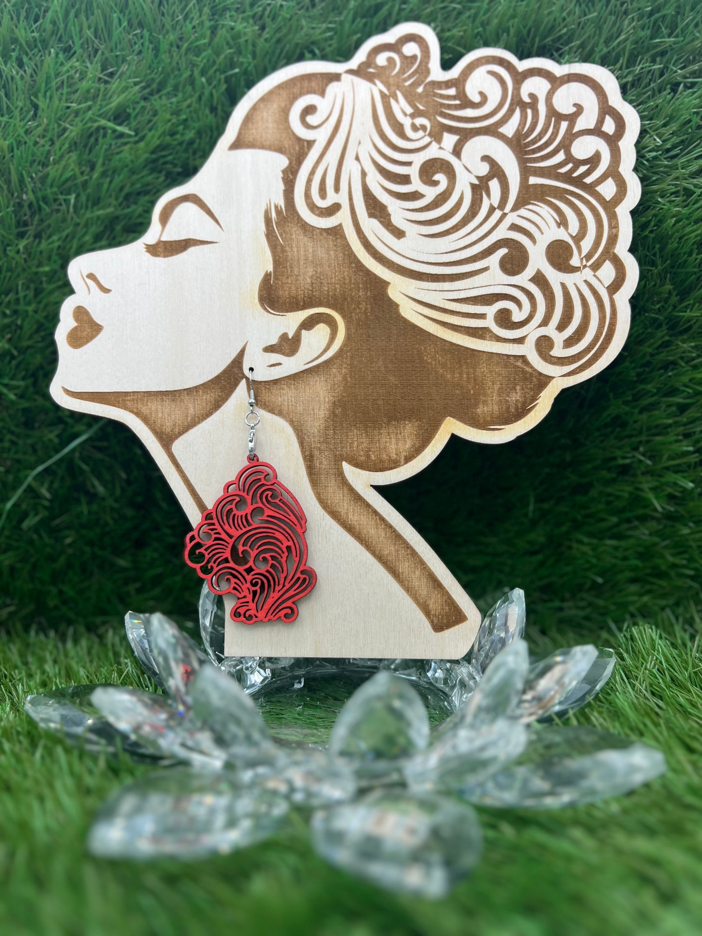 Elegant Boujee Stoner Vapor Earrings made from pink unicorn wood, displayed on a wooden earring stand shaped like a woman's profile.