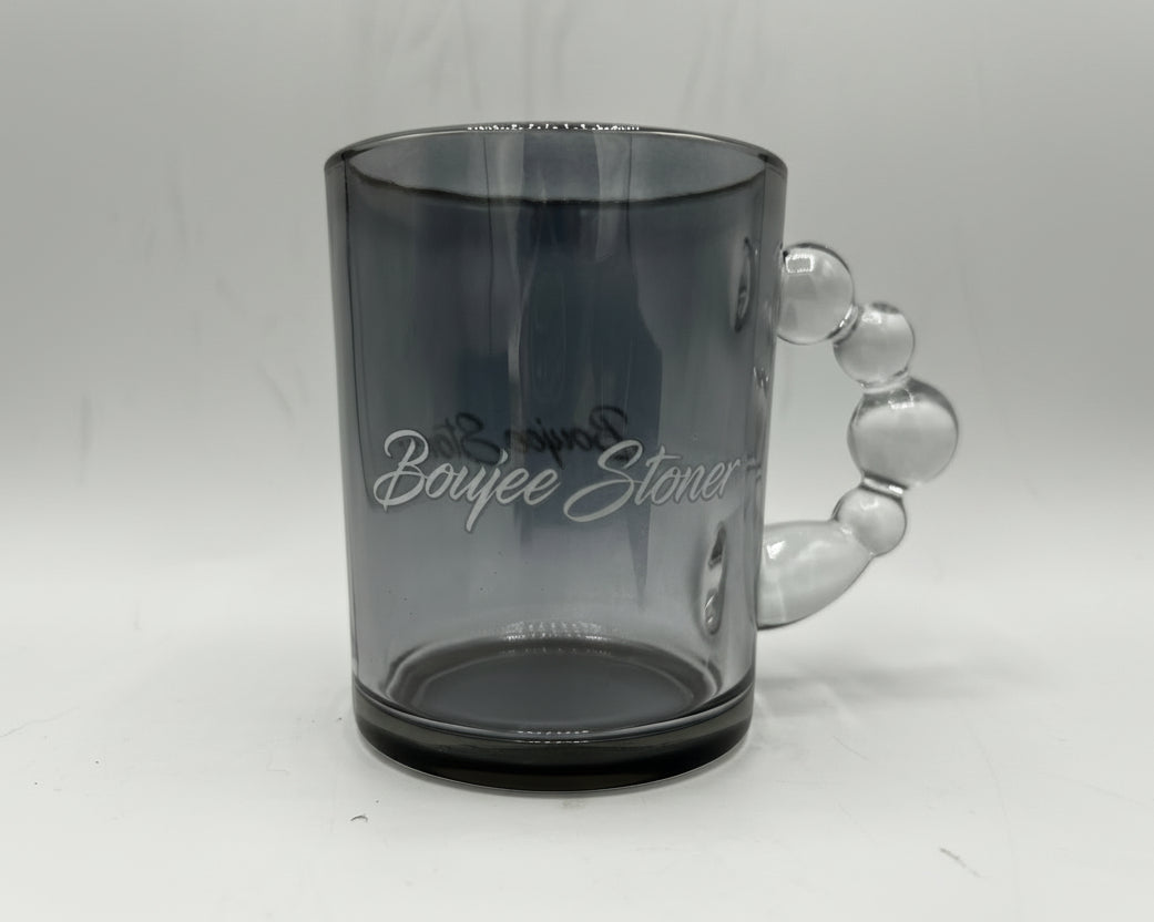 Clear glass mug with handle on a white background
